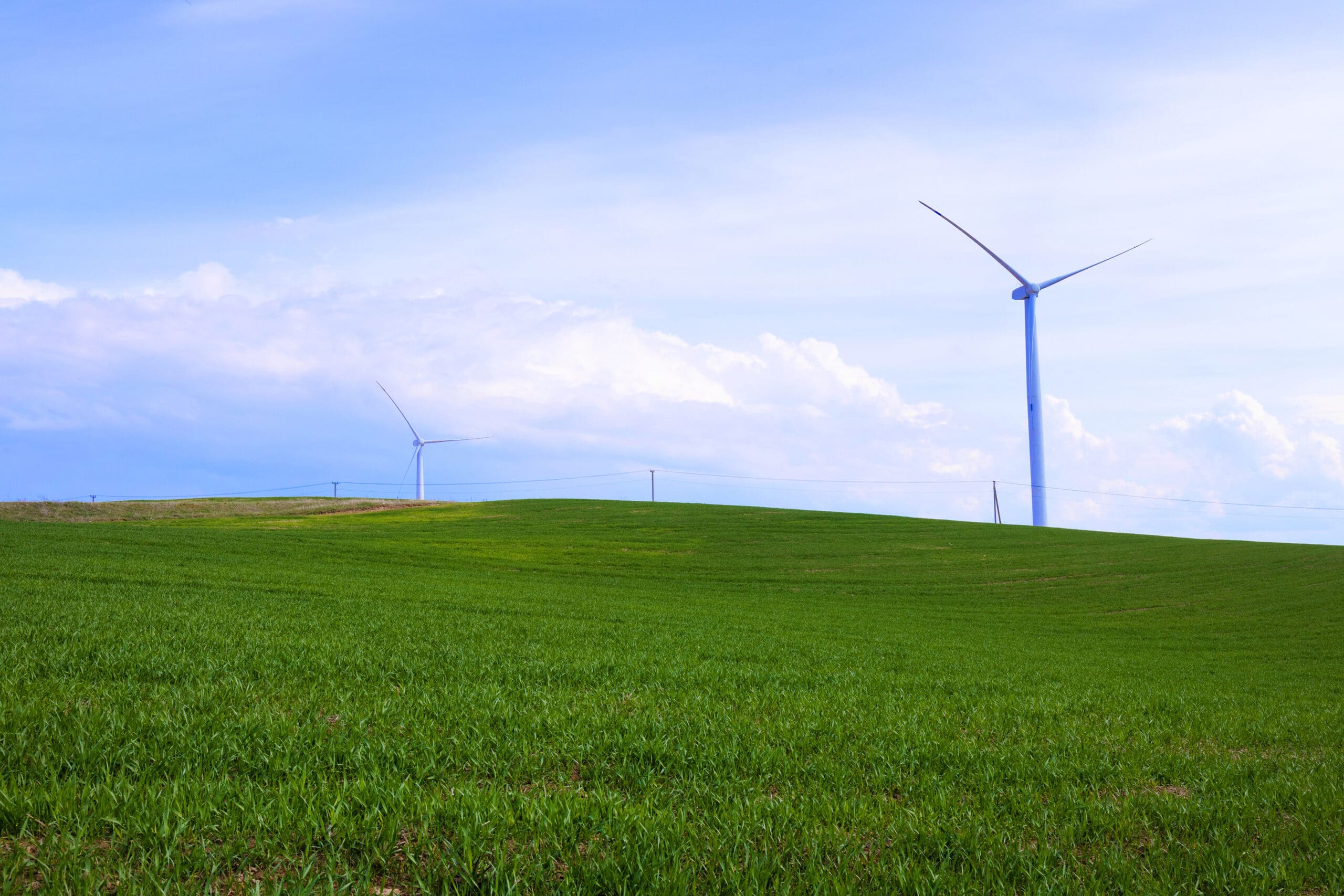 Modern wind turbine on blue sky background