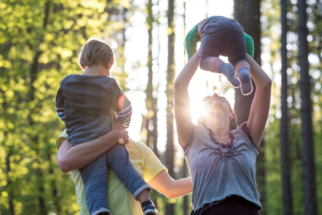 Parents playing with their two young children